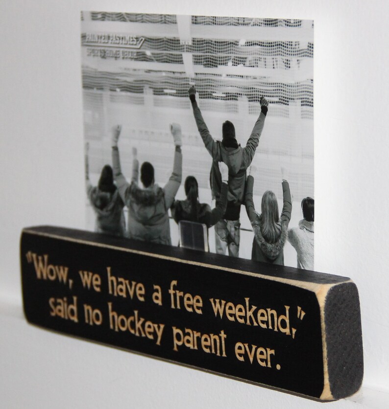 May include: Black wooden sign with white text that reads "Wow, we have a free weekend," said no hockey parent ever."