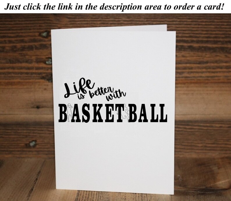 May include: A white card with black text that reads "Life is better with BASKETBALL". The word "Life" is written in a cursive font. The word "BASKETBALL" is in a bold, block font. There are two small silhouettes of basketball players on either side of the word "BASKETBALL".