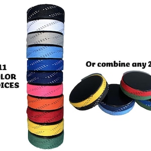 May include: A stack of eleven hockey skate laces in various colors, including black, white, gray, blue, navy, pink, orange, red, yellow, and green. The image also shows several hockey pucks with colored edges. Text reads "11 COLOR CHOICES" and "Or combine any 2".