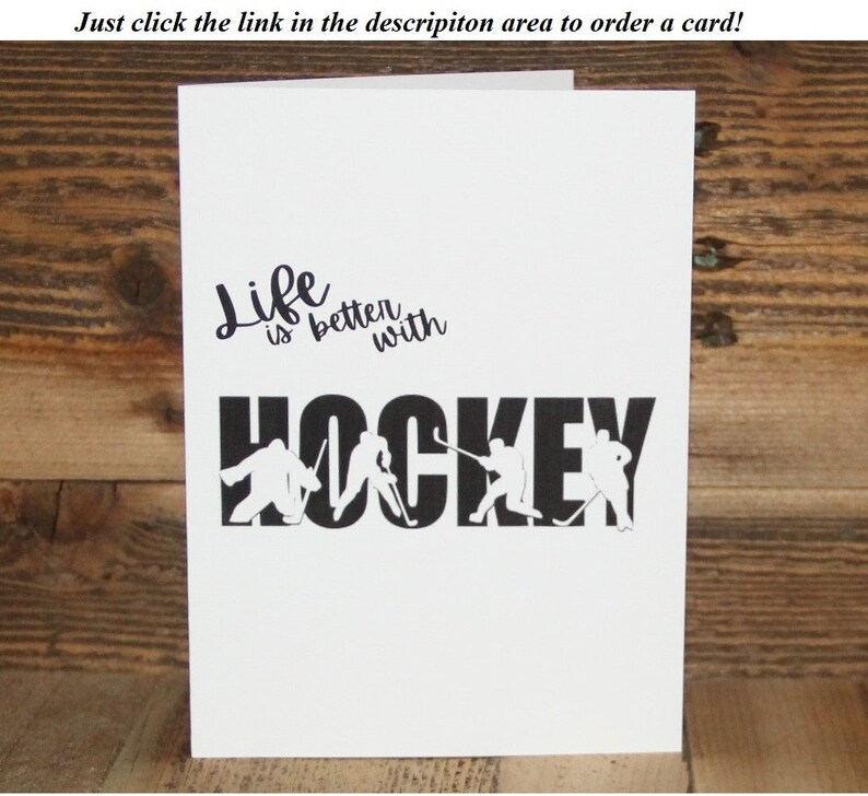 May include: A white card with black text that reads "Life is better with HOCKEY". The word "HOCKEY" is made up of hockey players in silhouette.