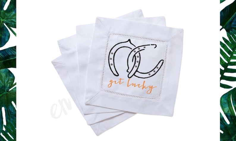 May include: Set of four white linen napkins with embroidered horseshoes and the text "get lucky" in orange.