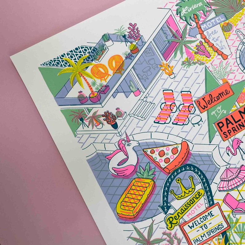 May include: A colorful illustration of a motel in Palm Springs, California. The illustration features a pool with a unicorn float, a pineapple float, and a slice of pizza. There are palm trees, lounge chairs, and a welcome sign that says "Welcome to Palm Springs".