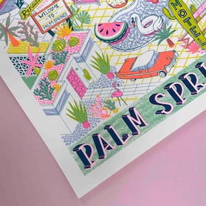May include: A colorful illustration of a Palm Springs scene with a retro car, a swimming pool, a flamingo, and a motel sign. The text "PALM SPRINGS" is in large, bold letters.