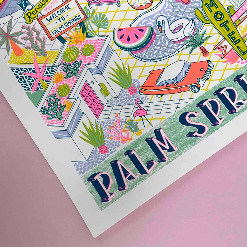 May include: A colorful illustration of a Palm Springs scene with a retro car, a swimming pool, a flamingo, and a motel sign. The text "PALM SPRINGS" is in large, bold letters.
