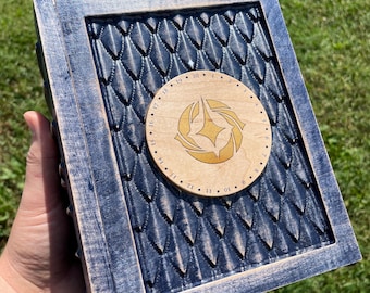 May include: A blue wooden box with a carved dragon scale design. The box has a circular wooden inlay with a gold design and numbers 1-20 around the edge.