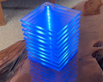 IKEA Tybble Lucite table lamp with blue light.