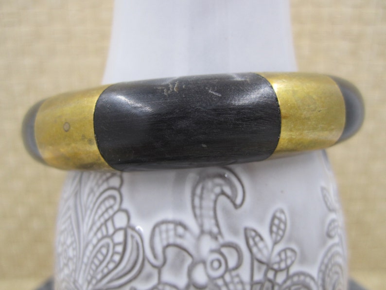 Beautiful artisan bangle in black with shiny brass strips