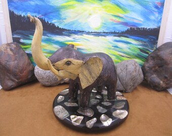 Elephant Sculpture set on a round marble plate with abalone shells
