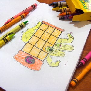 May include: A hand drawn illustration of a hand with a gridded box on top. The hand is yellow and the box is orange with a pink "C" inside. The illustration is on a white sheet of paper with colored pencils scattered around it.