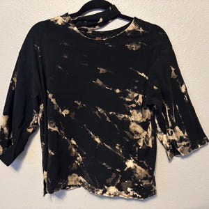reverse tie dye/bleach dye women’s top with neck cutout detail