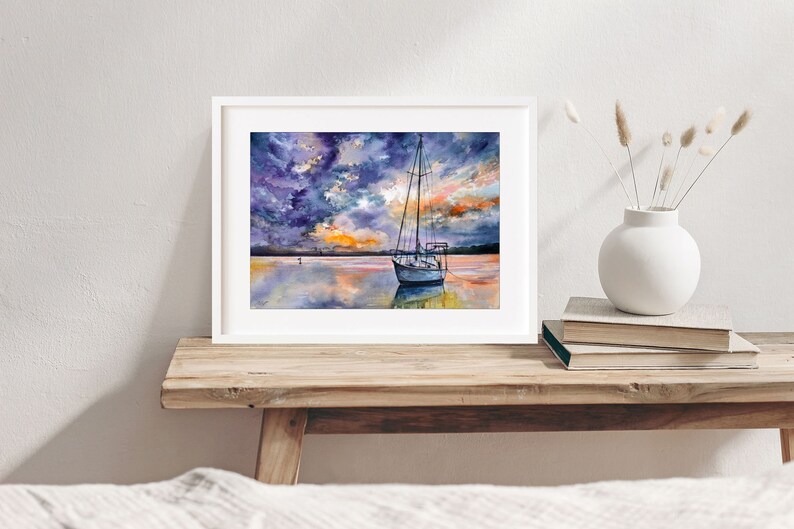 May include: A watercolor painting of a sailboat anchored in a calm body of water at sunset. The sky is a mix of purple, blue, and orange with clouds reflecting in the water.