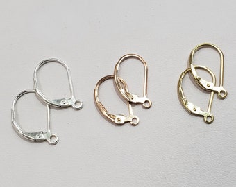 May include: Three pairs of earring hooks, one pair is silver, one pair is gold, and one pair is rose gold.