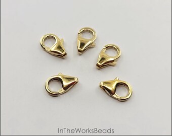 May include: Five gold-filled oval trigger lobster clasps, each measuring 10mm x 6mm. The clasps are made in the USA.