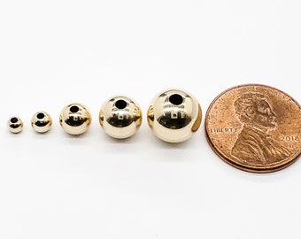 Cuentas redondas de oro macizo de 14 k de 1,8 mm, 2 mm, 2,5 mm, 3 mm, 4 mm, 6 mm, 8 mm y 10 mm. Cuentas huecas de peso medio. 1 unidad. Ahorro por volumen. Fabricado en EE. UU.