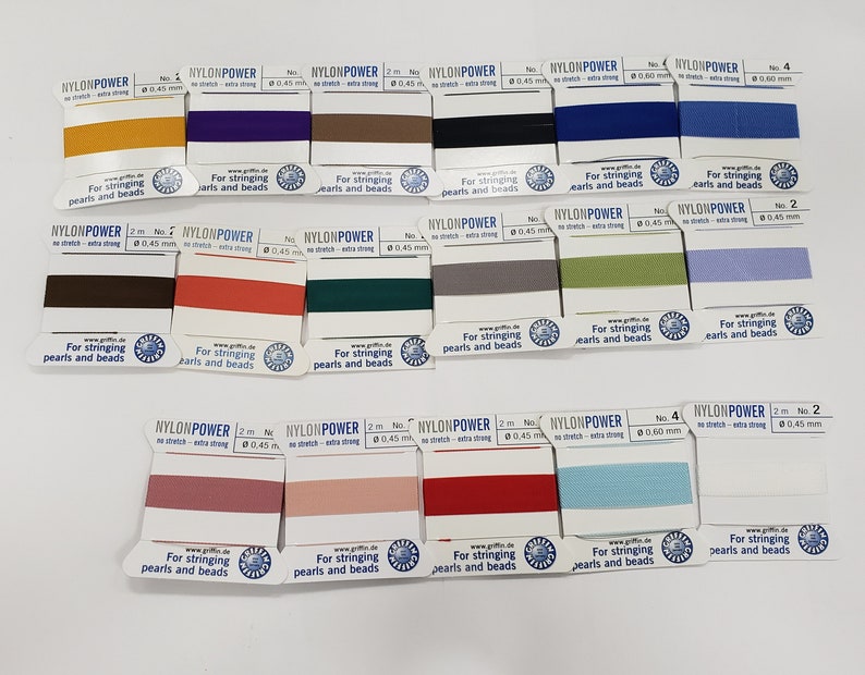 May include: Assortment of 2 meter spools of nylon thread in various colors, labeled "Nylon Power" for stringing pearls and beads. The spools are arranged in rows on a white surface.