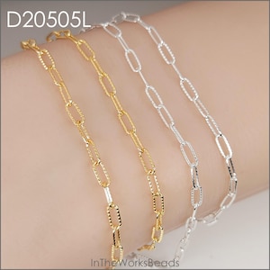 May include: Close-up of three delicate chain necklaces in gold and silver. The chains feature an oval link design. The text "D20505L" is in the upper left corner. The text "InTheWorksBeads" is in the lower right corner.