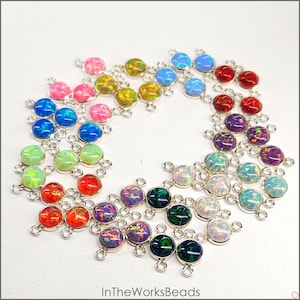 May include: Assortment of colorful opal gemstone connector charms with silver-toned metal settings. Each charm features three loops for attaching to jewelry pieces.