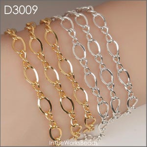 May include: Close-up of gold and silver chain bracelets. The bracelets feature oval links connected by twisted links. The gold bracelets are on the left, and the silver bracelets are on the right. The text "D3009" is in the upper left corner.