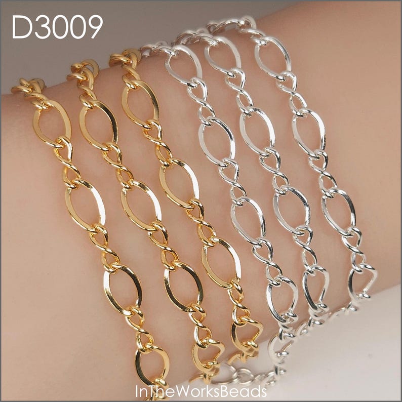 May include: Close-up of gold and silver chain bracelets. The bracelets feature oval links connected by twisted links. The gold bracelets are on the left, and the silver bracelets are on the right. The text "D3009" is in the upper left corner.