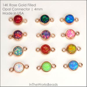 May include: A collection of 14K rose gold filled opal connectors. Each connector features a 4mm round opal stone in various colors, including red, green, blue, and pink. The connectors are designed with small loops on each side for easy attachment.