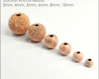 May include: Six rose gold filled round beads with a stardust finish. The beads are arranged in order of size from largest to smallest, with the largest bead measuring 10mm and the smallest bead measuring 3mm.