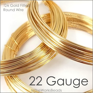 May include: Close-up of 12k gold filled round wire in 22 gauge. The wire is coiled and appears shiny and bright gold. The text "12k Gold Filled Round Wire" and "22 Gauge" is visible in the image. The text "InTheWorksBeads" is also visible in the image.
