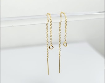 May include: Two gold chain earring findings with a small jump ring at the top and a straight wire at the bottom.