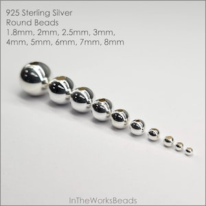 May include: A set of 925 sterling silver round beads in various sizes, ranging from 1.8mm to 8mm. The beads are arranged in a line from largest to smallest.