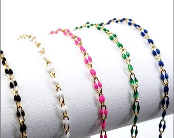 May include: Five gold-tone metal chains featuring small, elongated, enamel-coated links in black, white, pink, green, and blue. Each chain consists of repeating oval-shaped segments connected by thin gold wire, creating a delicate, uniform pattern.