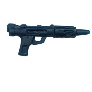 May include: A dark blue toy blaster gun with a handle, trigger, and barrel. The toy gun is made of plastic and has a detailed design with ridges and grooves. The toy gun is a replica of a sci-fi weapon.