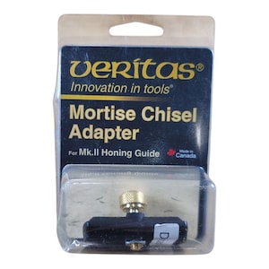 May include: A Veritas Mortise Chisel Adapter for Mk.II Honing Guide, packaged in a clear plastic blister pack. The adapter is black with a gold-colored adjustment knob. The packaging includes the text "Innovation in tools" and "Made in Canada."