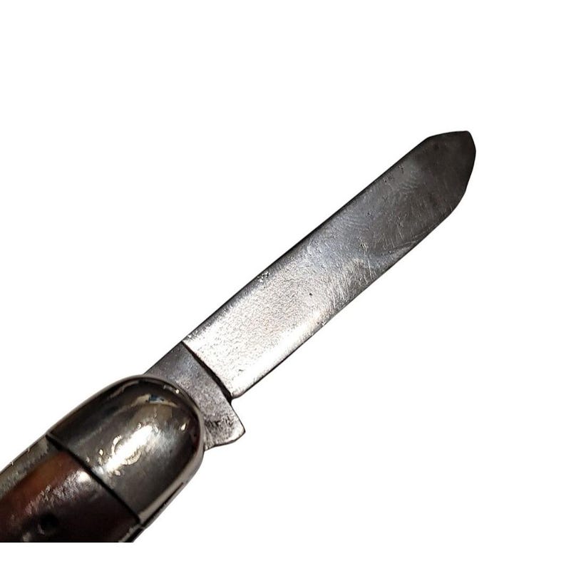 May include: A close-up of a silver pocket knife with a wooden handle. The blade is open and the tip is pointed.