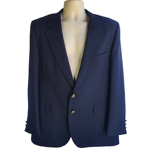 May include: A navy blue blazer with gold buttons. The blazer has a single breasted closure and two flap pockets.