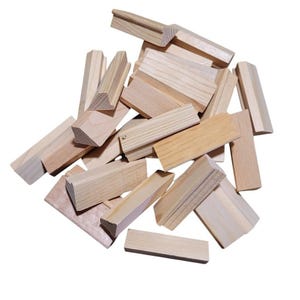 May include: A pile of unfinished wooden blocks, varying in size and shape, are scattered against a white background. The blocks are made of light-colored wood, with visible grain patterns. Some blocks are rectangular, while others have angled edges, suggesting a building or stacking toy.