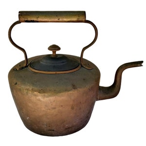 May include: An antique copper kettle with a brass handle and a black lid. The kettle has a worn, aged patina and is a vintage kitchen item.
