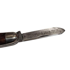 May include: A vintage pocket knife with a wooden handle and a partially open blade. The blade is made of metal and has a slight curve.