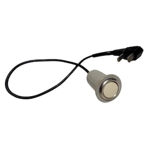 May include: A white push button switch with a black wire and a silver housing. The switch is connected to a black wire that is looped into a circle.