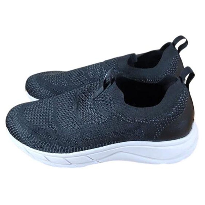 May include: A pair of black slip-on sneakers with a textured knit upper and a white sole. The shoes have a pull tab at the heel for easy wear. The design is minimalist and suitable for casual wear.
