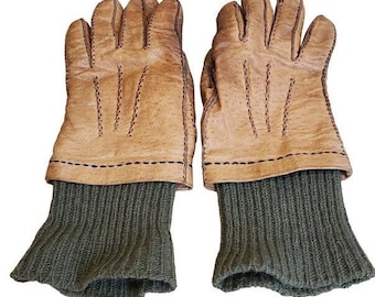 May include: A pair of brown leather gloves with green knitted cuffs. The gloves have a stitched design and are made of a soft, supple leather.