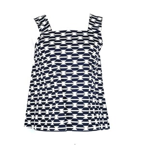 May include: A sleeveless top with a black and white geometric pattern. The top has a square neckline and wide straps.