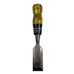 May include: A metal chisel with a yellow handle and the text "FUMER SUPER SHARP No. 954-". The chisel has a silver blade with the number "1" etched on it. The tool is designed for woodworking and carpentry.