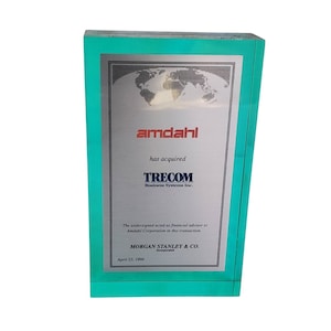 May include: A teal blue plaque with a silver plaque inset. The silver plaque has a world map design and the text "amdahl has acquired TRECOM Business Systems Inc. The undersigned acted as financial advisor to Amdahl Corporation in this transaction. MORGAN STANLEY & CO. Incorporated April 23, 1996."