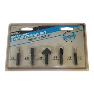 May include: A 5-piece router bit set for surface and sign work. The set includes bits labeled 1/8" straight, 3/8" straight, 7/8" V-groove, 3/8" core box, and 1/8" veining. The package is labeled "Credo Dura-Sharp" and "Made in USA."