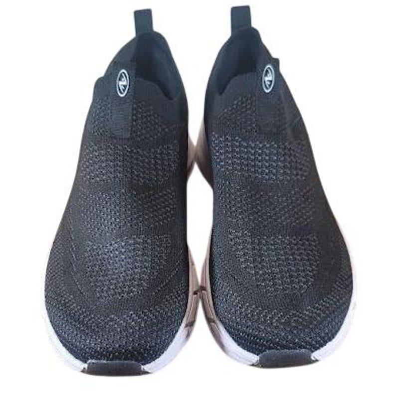 May include: Pair of black slip-on sneakers with a textured knit upper and white soles. The shoes have a rounded toe and a small loop at the back for easy wear. A circular logo is visible on the side of each shoe.