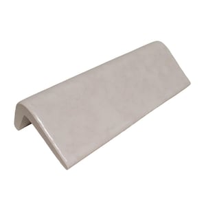 May include: White ceramic tile with a rounded edge, designed for use as a corner trim piece.