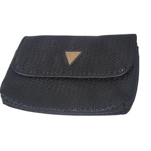 May include: A black leather clutch purse with a gold triangular logo.