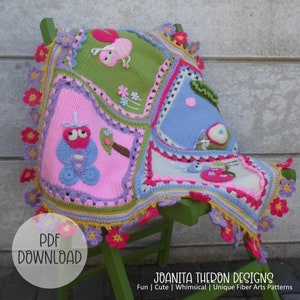 May include: A crocheted baby blanket with a colorful patchwork design featuring butterflies, flowers, and a ladybug. The blanket has a scalloped edge with crocheted flowers.