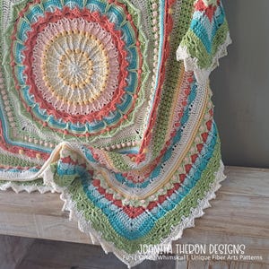 May include: A colorful, handmade crochet blanket with a circular design. The blanket features a variety of pastel colors, including pink, blue, green, and yellow, with a scalloped edge. The text "JOANITA THERON DESIGNS" is visible.