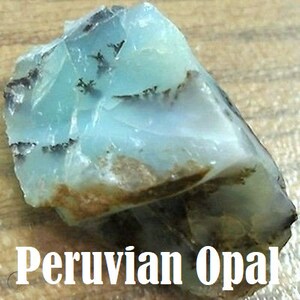 May include: A rough, light blue Peruvian opal with dark gray and brown markings.