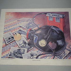 May include: A watercolour painting of a black miner's helmet with a safety light and a tag that reads "Safety First 1948". The helmet is surrounded by old photographs of mining equipment and landscapes. The painting is titled "Mining Memories".